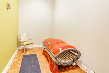 a steam room with an orange boiler in the corner of a room